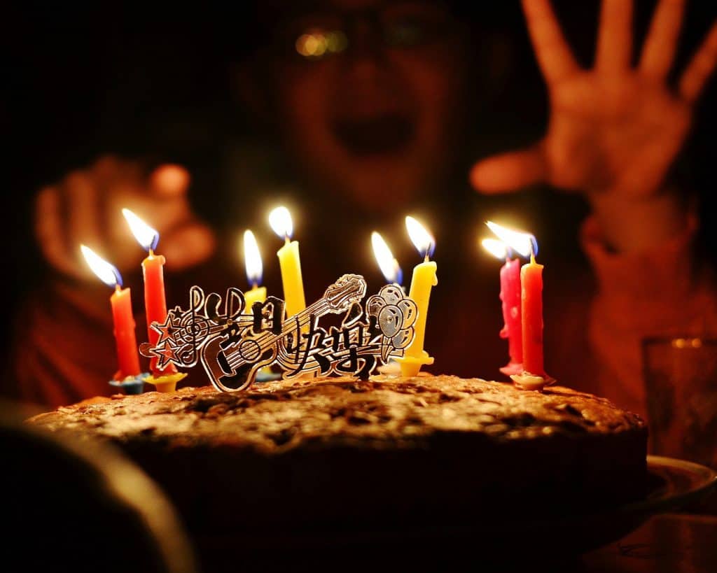 a boy celebrates his birthday with a cake.