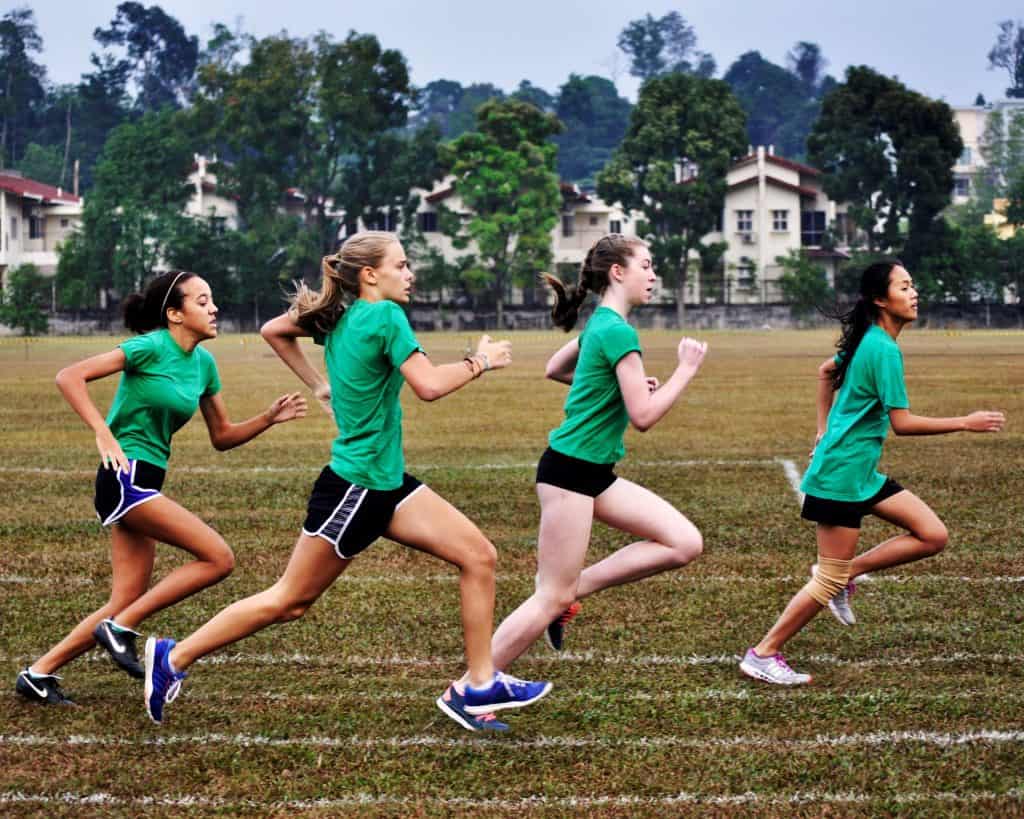 four girls running in a race.