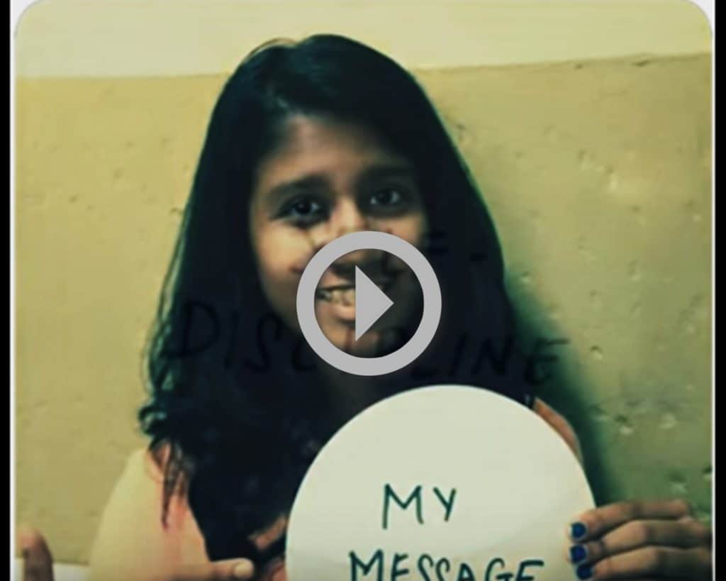 A girl holds a sign with the words My Message.