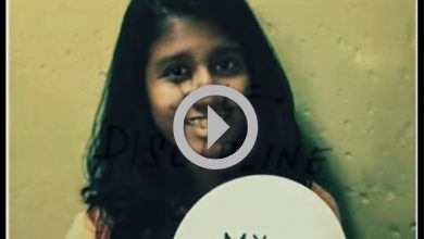 A girl holds a sign with the words My Message.