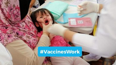 A young girl is immunised by a nurse from the Ministry of Health