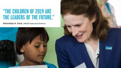 UNICEF Executive Director Henrietta Fore with a child. In the photo a box with the caption "The children of 2019 are the leaders of the future".