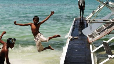 Boys playing in the sea.