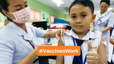 Boy receives a vaccine from a nurse.