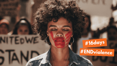 young woman at a women's march calling for end to gender based violence